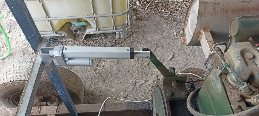 Linear actuator mounted on engine frame connecting to throttle and brake mechanism
