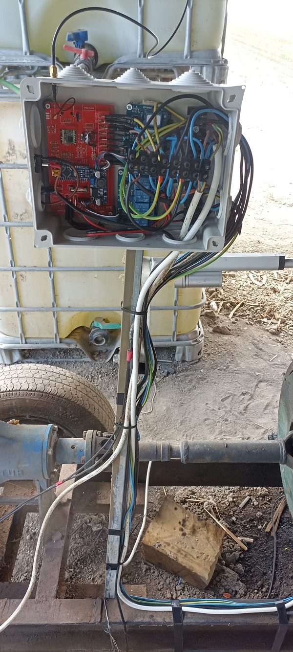Weatherproof enclosure open showing PCB, relay board, Arduino, and cable management installed on engine frame